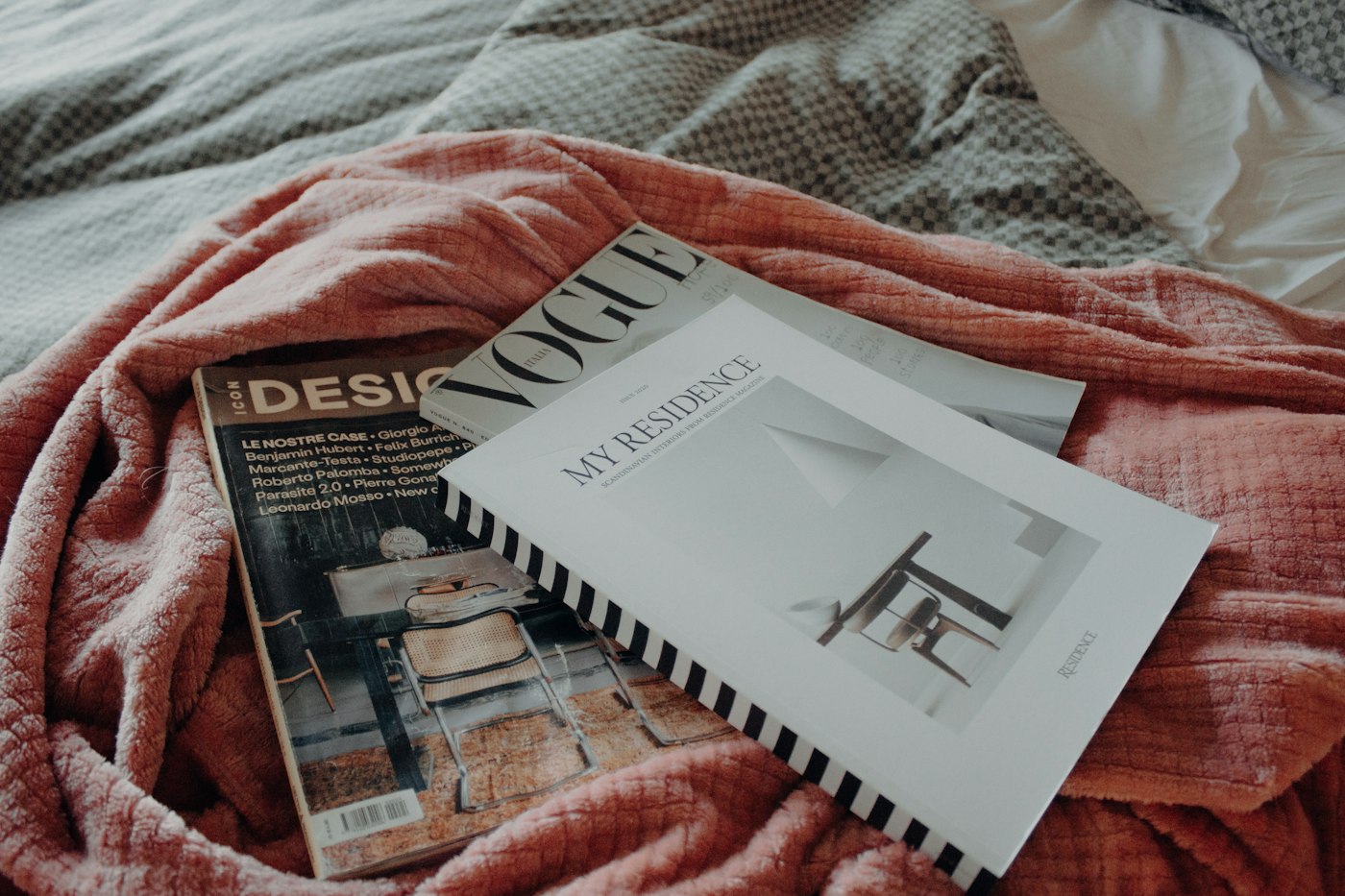 Book on a cozy red blanket in bed
