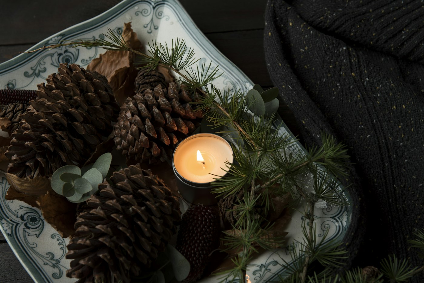Candle with pinecones, a cozy homebody gift idea