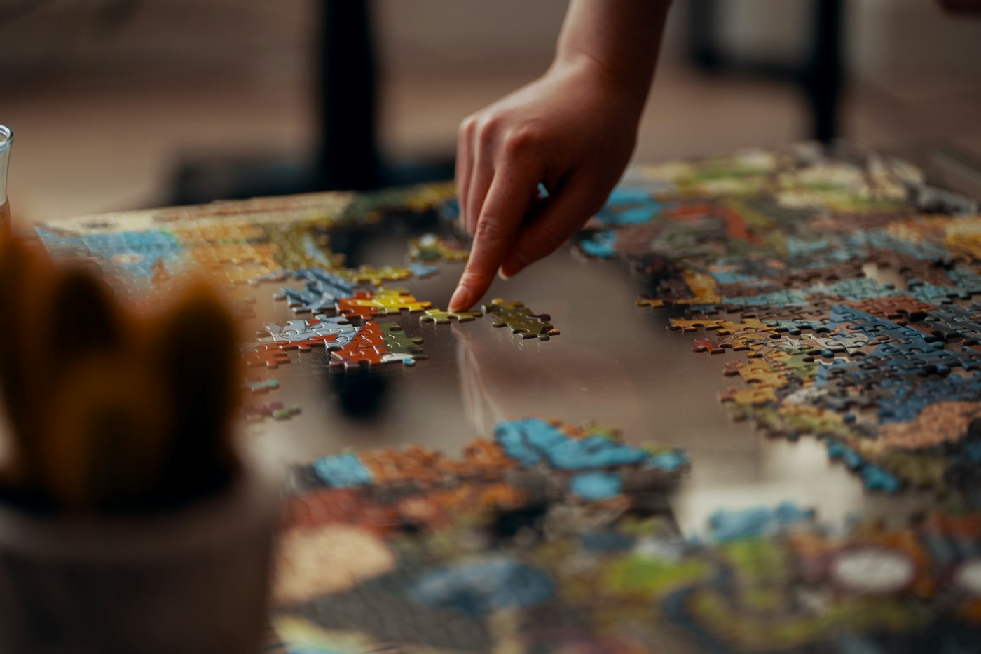 Hand holding a jigsaw puzzle piece