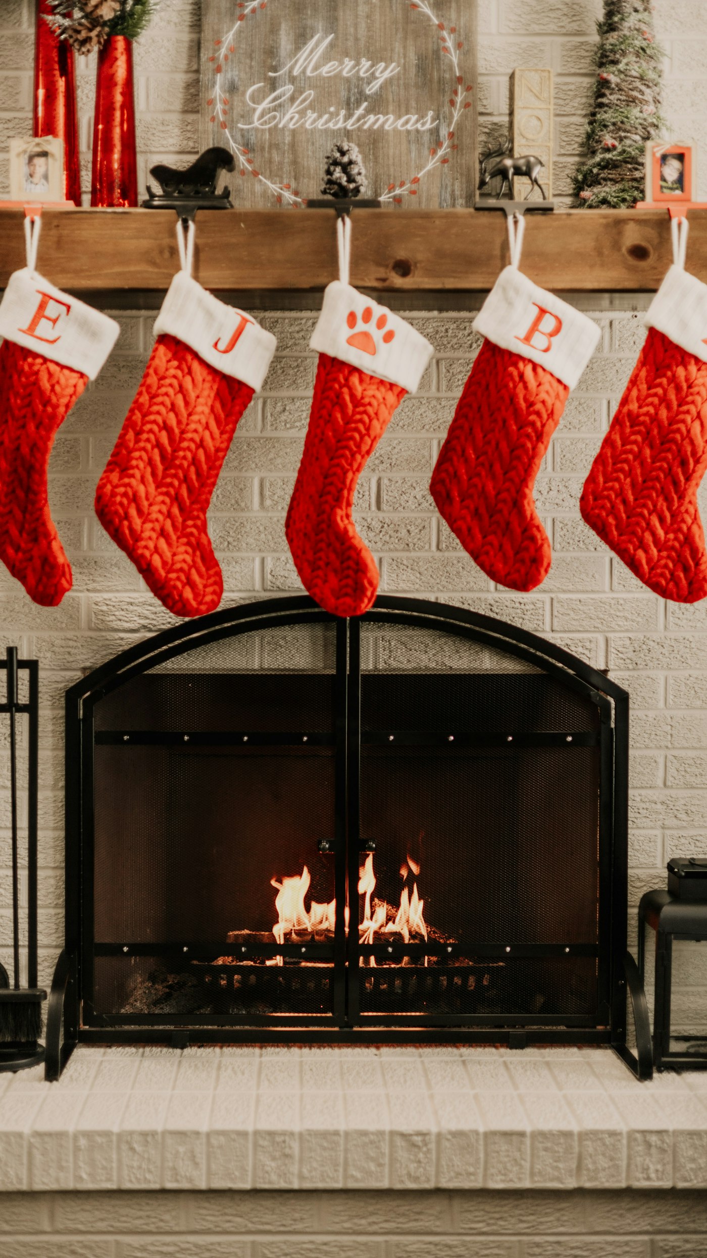 Christmas stockings hanging over a fireplace, ready for stocking stuffers