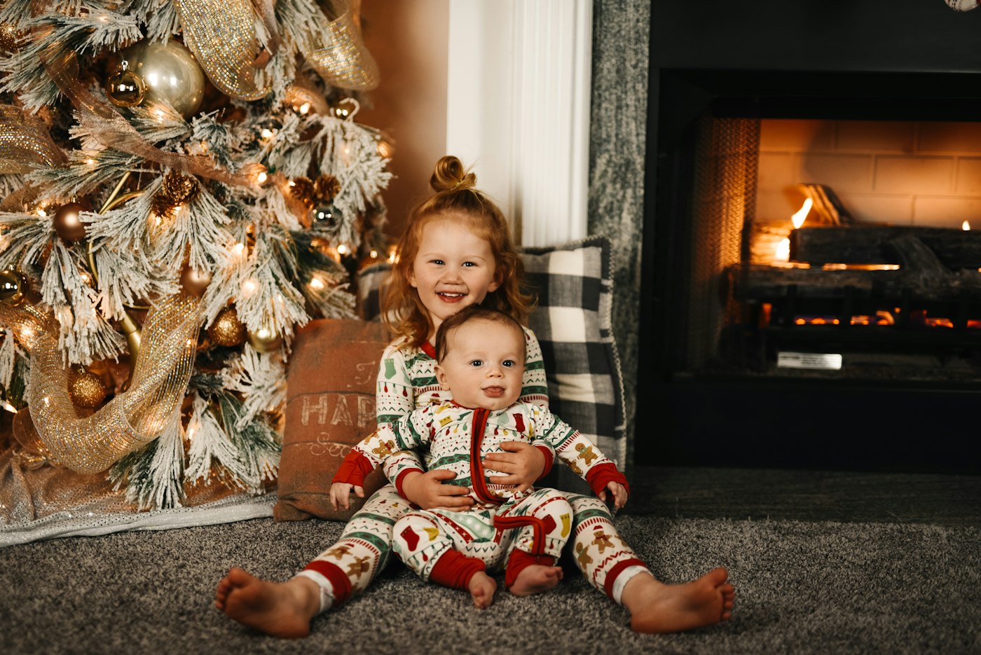 Child on Christmas morning opening stocking stuffers by the tree